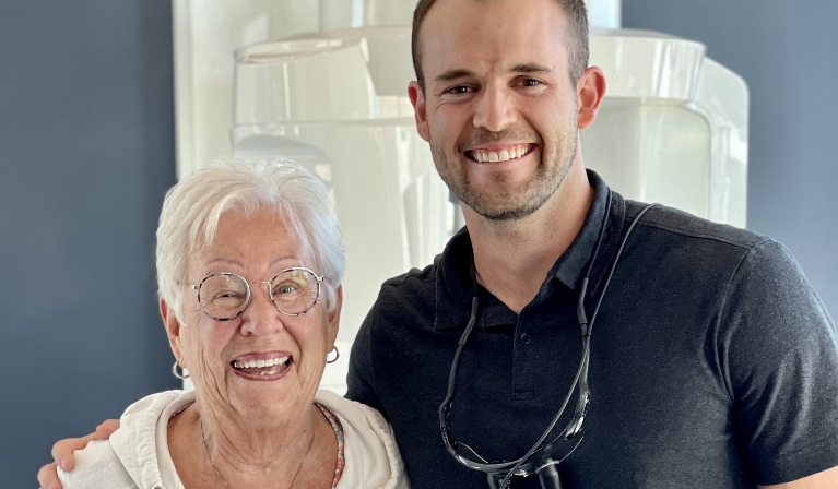 Doctor Julian smiling with senior woman