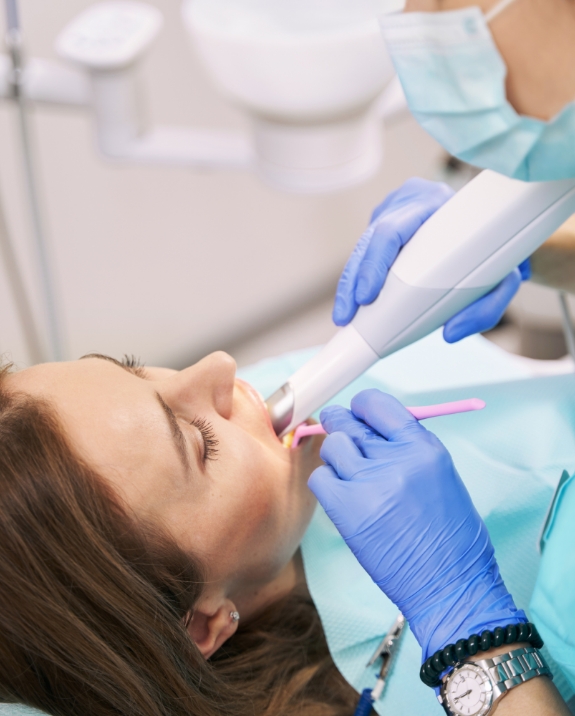 Dentist taking digital dental impressions of a patient